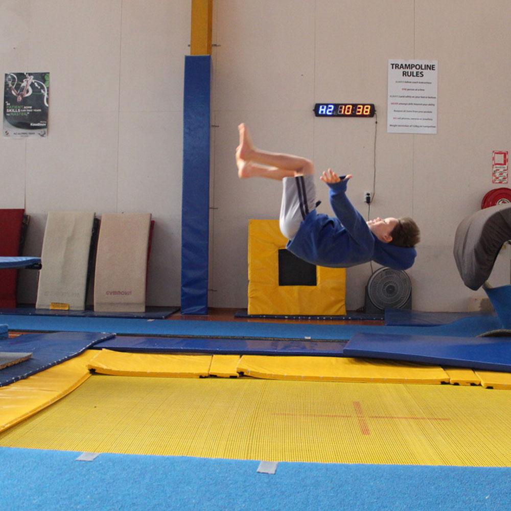 Boy flipping gymnastics trampoline